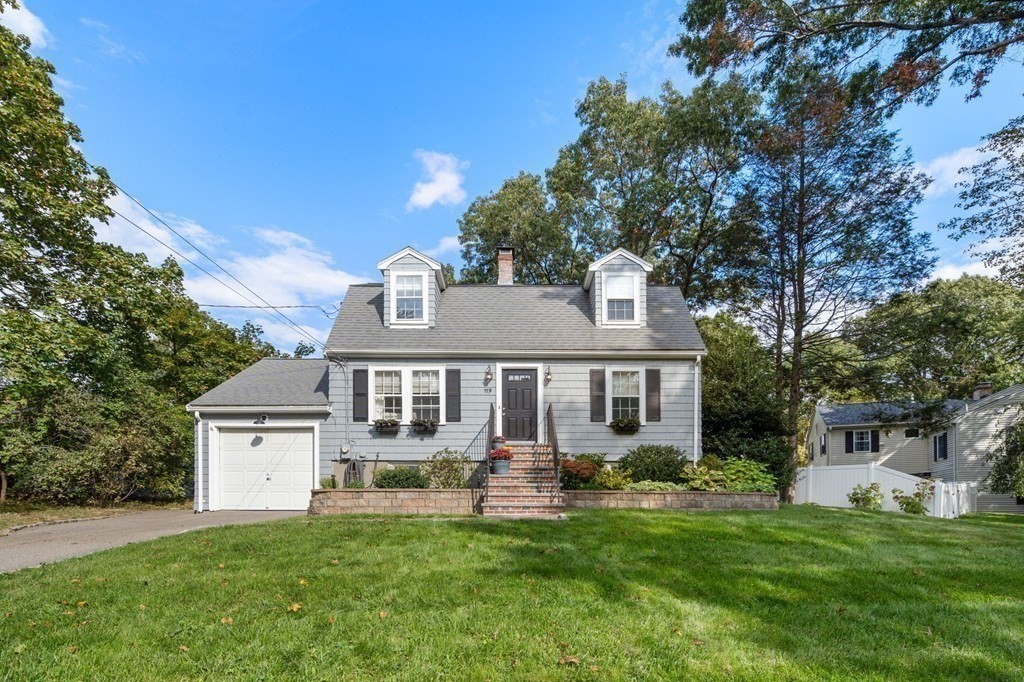 119 Sylvan Road Needham, MA 02492 - Photo 22 of 23 a front view of a house with a yard table and chairs