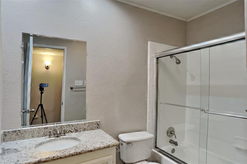 2709 Roman Way Garland, TX 75040 - Photo 14 of 16 a bathroom with a granite countertop sink toilet and shower