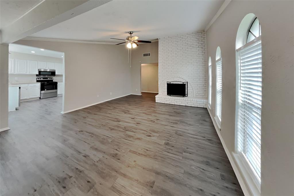 2709 Roman Way Garland, TX 75040 - Photo 3 of 16 wooden floor in an empty room with a window