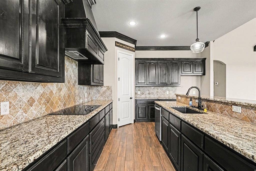 104 Stanford Lane Springtown, TX 76082 - Photo 8 of 28 a kitchen with stainless steel appliances granite countertop counter space a sink and cabinets