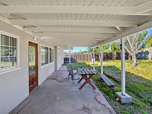 9462 Doheny Road Santee, CA 92071 - Photo 26 of 33 a view of a patio with table and chairs potted plants with wooden floor