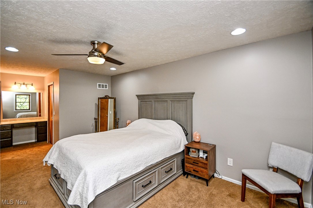 1236 Spring Valley Avenue Northwest Canton, OH 44708 - Photo 10 of 28 Bedroom featuring recessed lighting, light carpet, a textured ceiling, and a ceiling fan