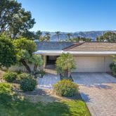 a view of a backyard with plants and a patio