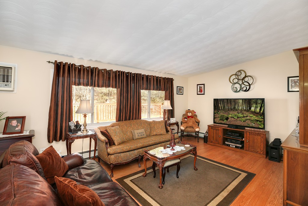 63 Griffin Road Framingham, MA 01701 - Photo 11 of 23 a living room with furniture and a flat screen tv