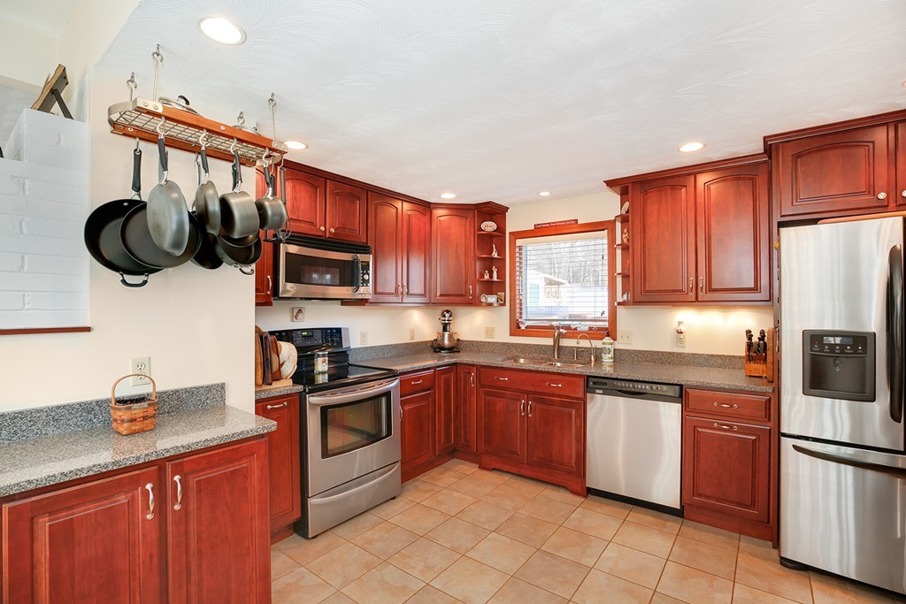 63 Griffin Road Framingham, MA 01701 - Photo 4 of 23 a kitchen with stainless steel appliances granite countertop a sink and cabinets