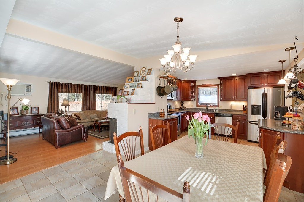 63 Griffin Road Framingham, MA 01701 - Photo 8 of 23 a view of a dining room with furniture a kitchen and chandelier