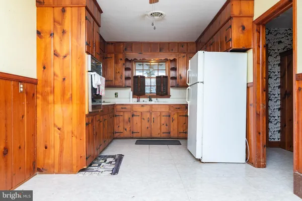 a kitchen with refrigerator and cabinets