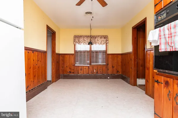 a view of an empty room with a window and a flat screen tv