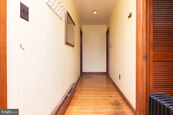 a view of a hallway with wooden floor