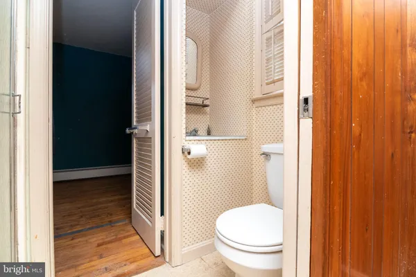 a bathroom with a granite countertop toilet and a shower
