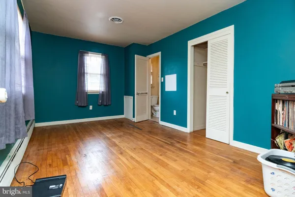 an empty room with windows and closet