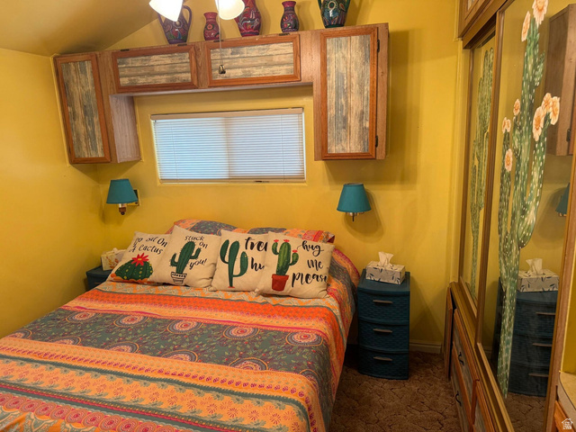 1225 North Dixie Downs Road, Unit 100 St. George, UT 84770 - Photo 17 of 22 Bedroom featuring built-in cabinetry, window with blinds, and wall-mounted light fixtures