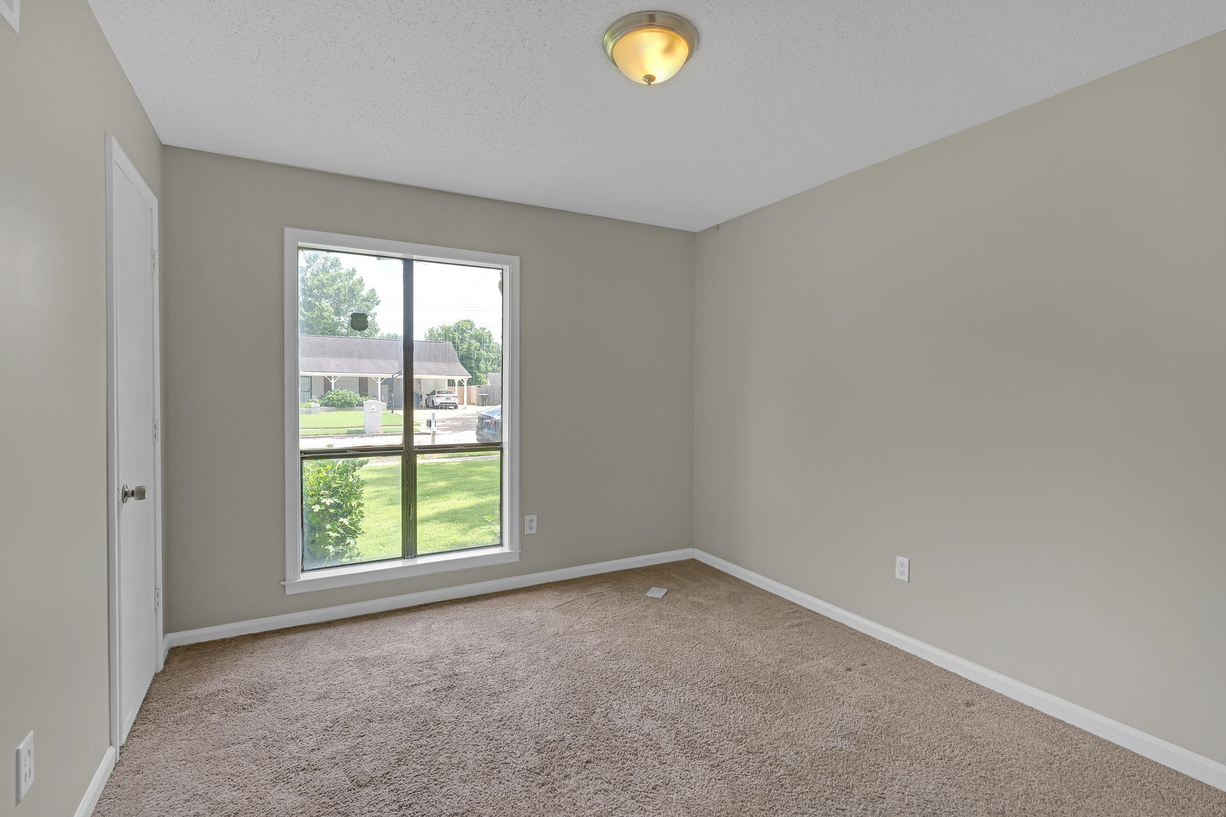 6128 Raintree Drive Memphis, TN 38115 - Photo 17 of 30 Spare room with light carpet and a textured ceiling
