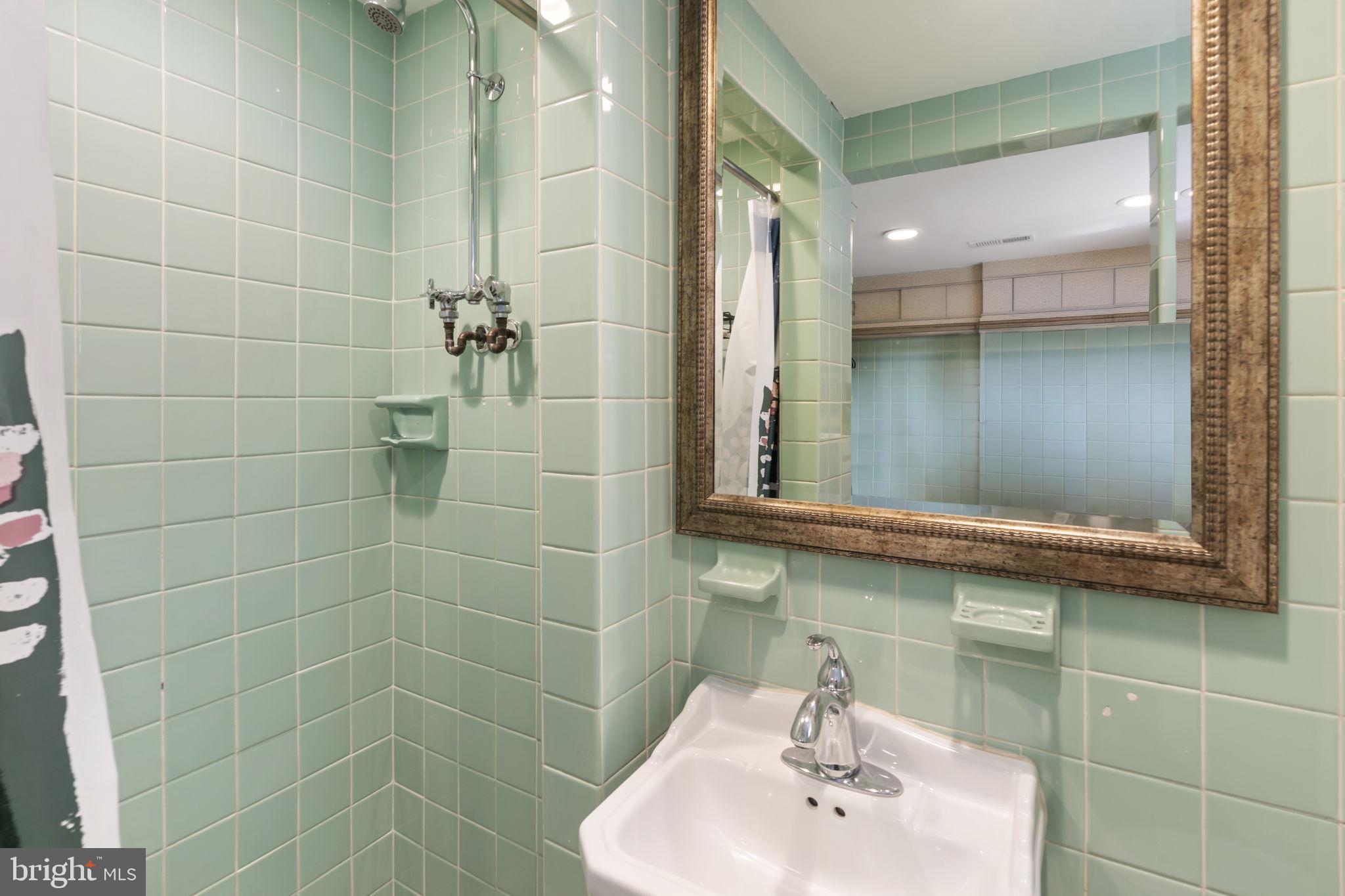 352 South New Middletown Road Media, PA 19063 - Photo 32 of 41 a bathroom with a sink a glass door shower and a mirror