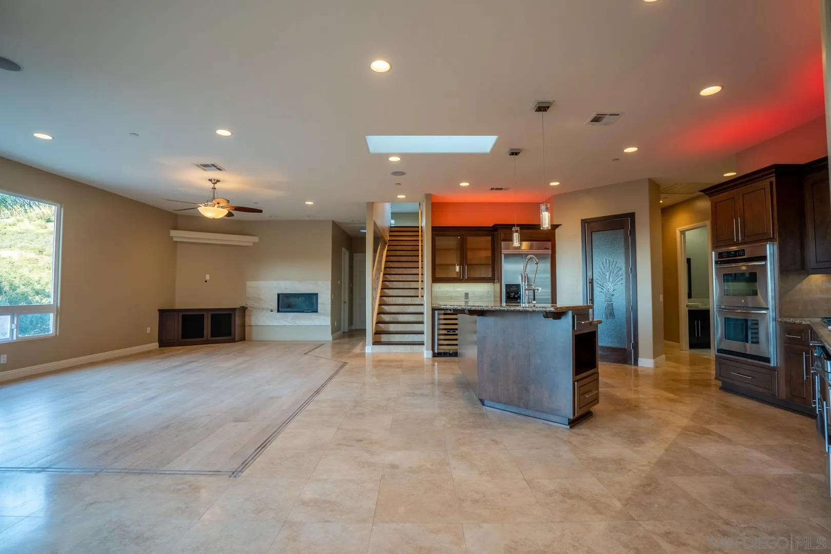 14184 Ridge Canyon Road Valley Center, CA 92082 - Photo 9 of 39 an empty room with furniture and a kitchen