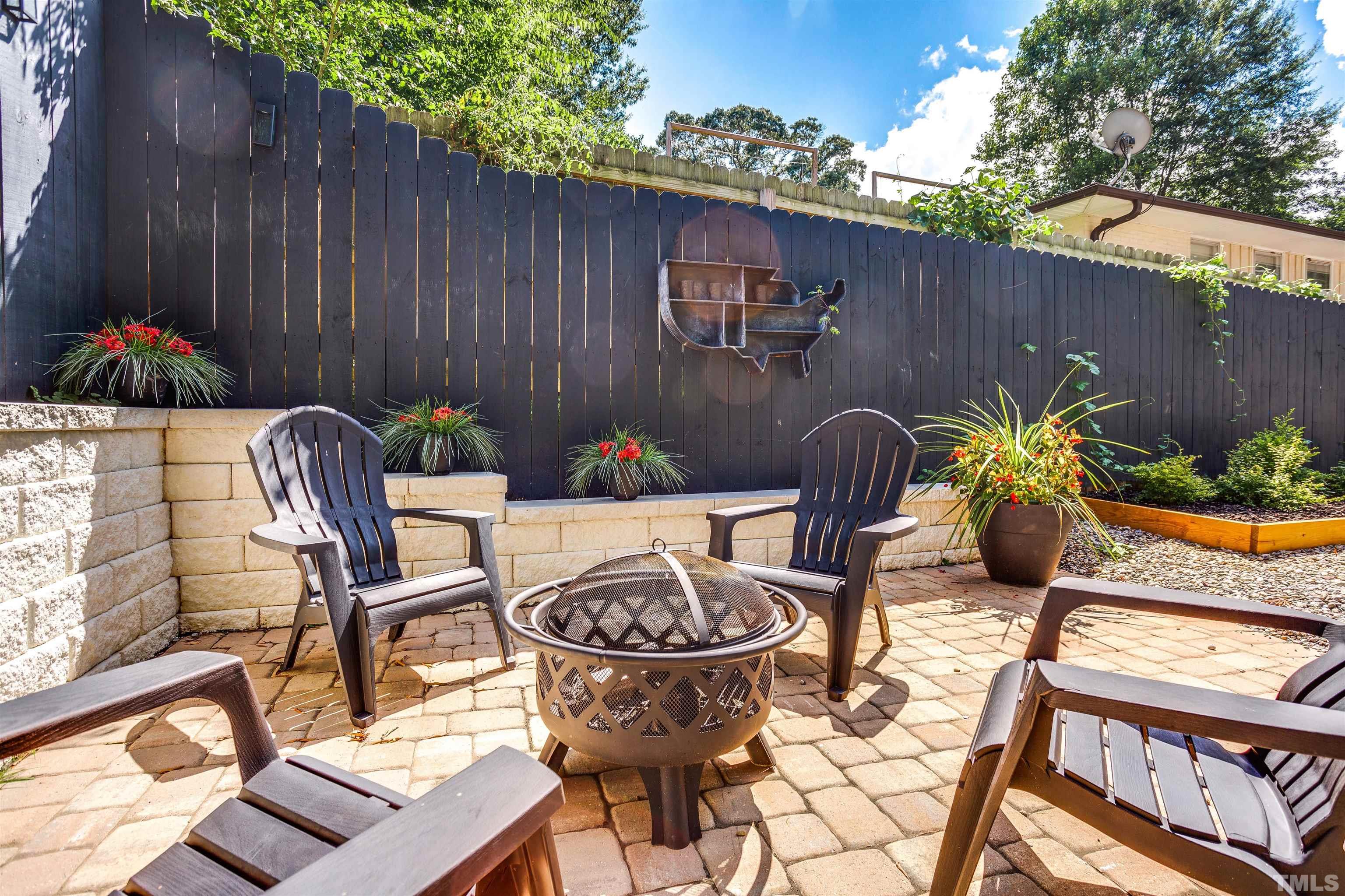 2116 Bellaire Avenue Raleigh, NC 27608 - Photo 22 of 26 a backyard of a house with table and chairs