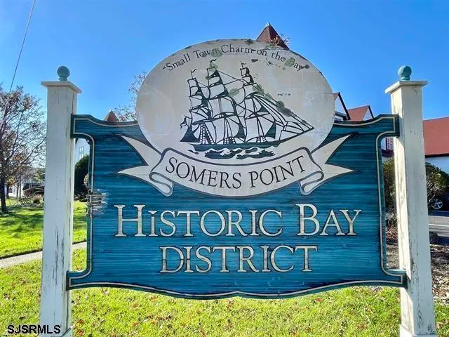 a view of a wooden house with a sign on the wall