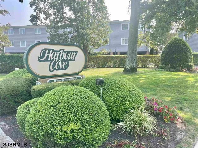 a sign board with a house and garden