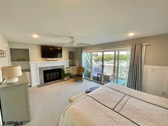 a spacious bedroom with a bed and a large window