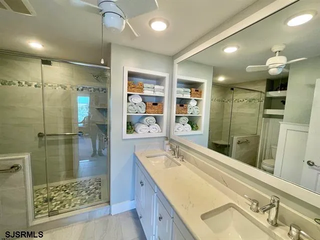 a bathroom with a tub sink shower and mirror