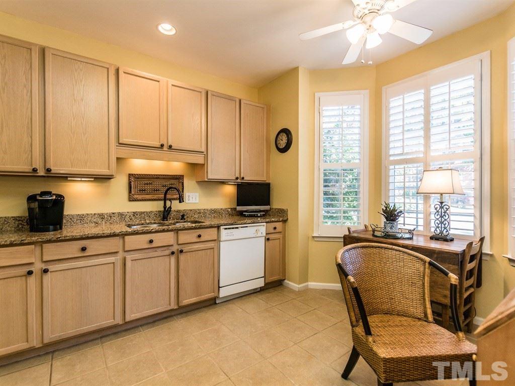 5621 Slide Rock Lane Raleigh, NC 27613 - Photo 6 of 23 a kitchen with stainless steel appliances granite countertop a stove a sink and white cabinets