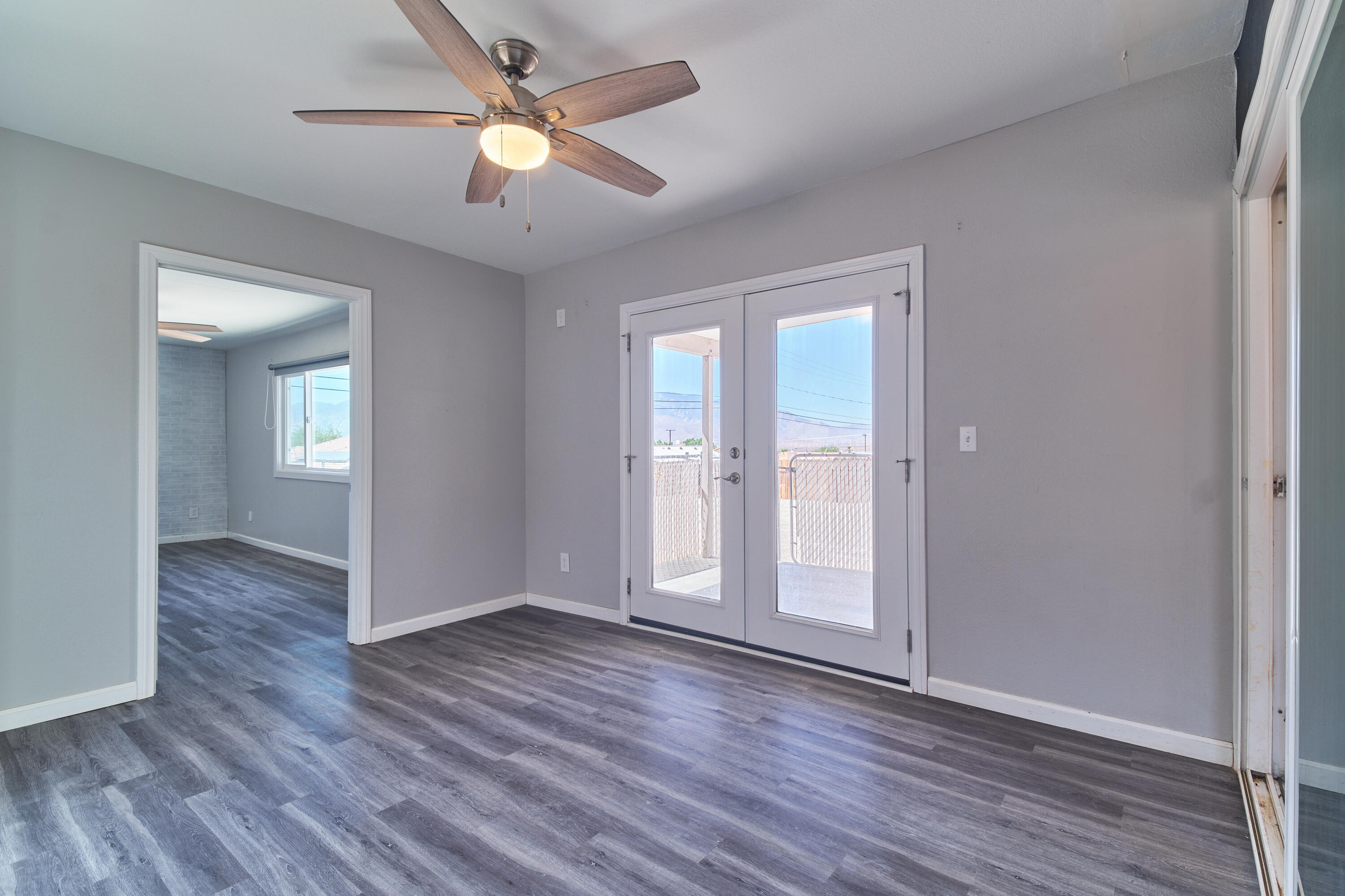 66097 San Jose Road Desert Hot Springs, CA 92240 - Photo 12 of 26 wooden floor in an empty room with a window