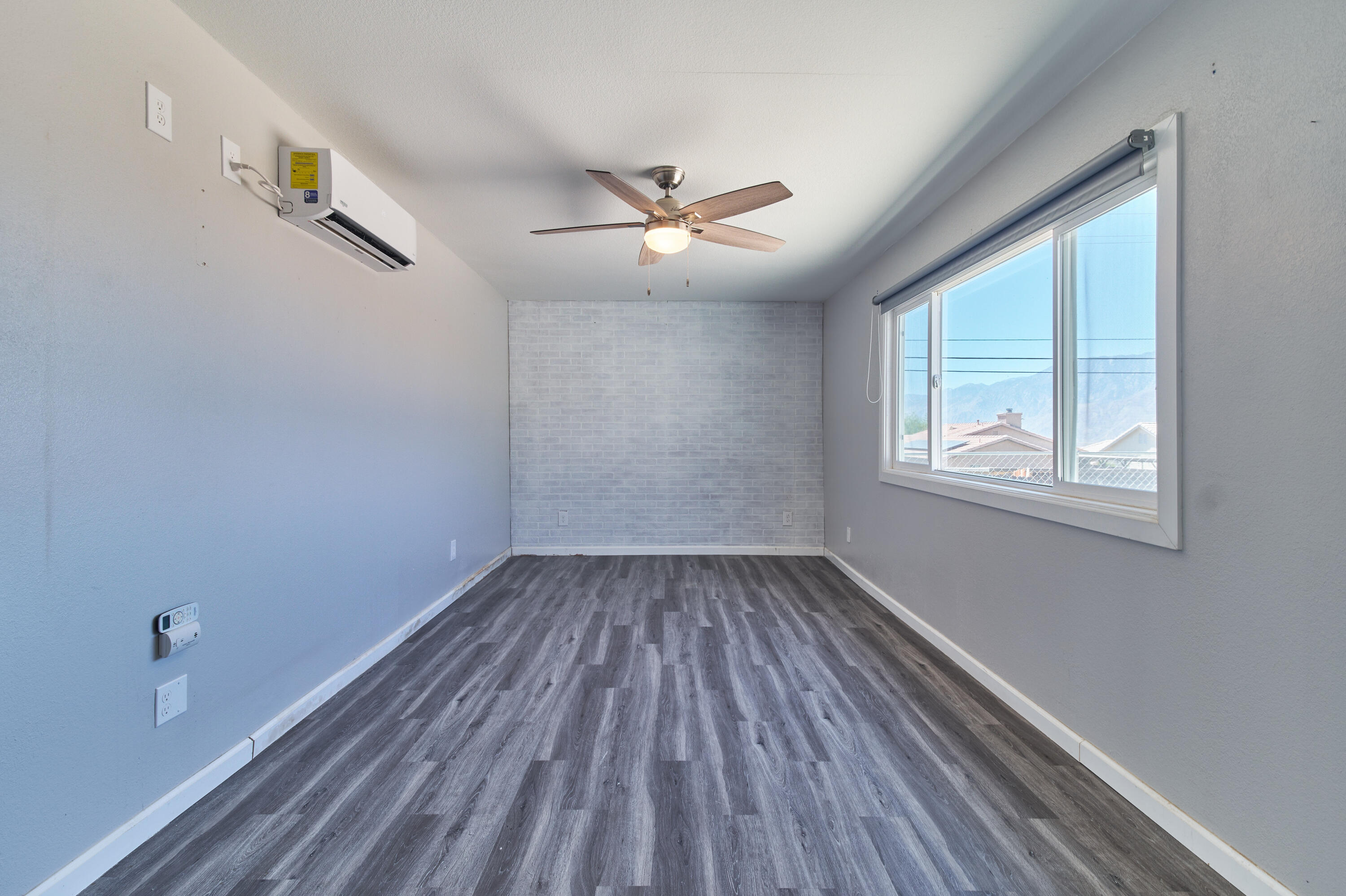 66097 San Jose Road Desert Hot Springs, CA 92240 - Photo 14 of 26 wooden floor in an empty room with a window