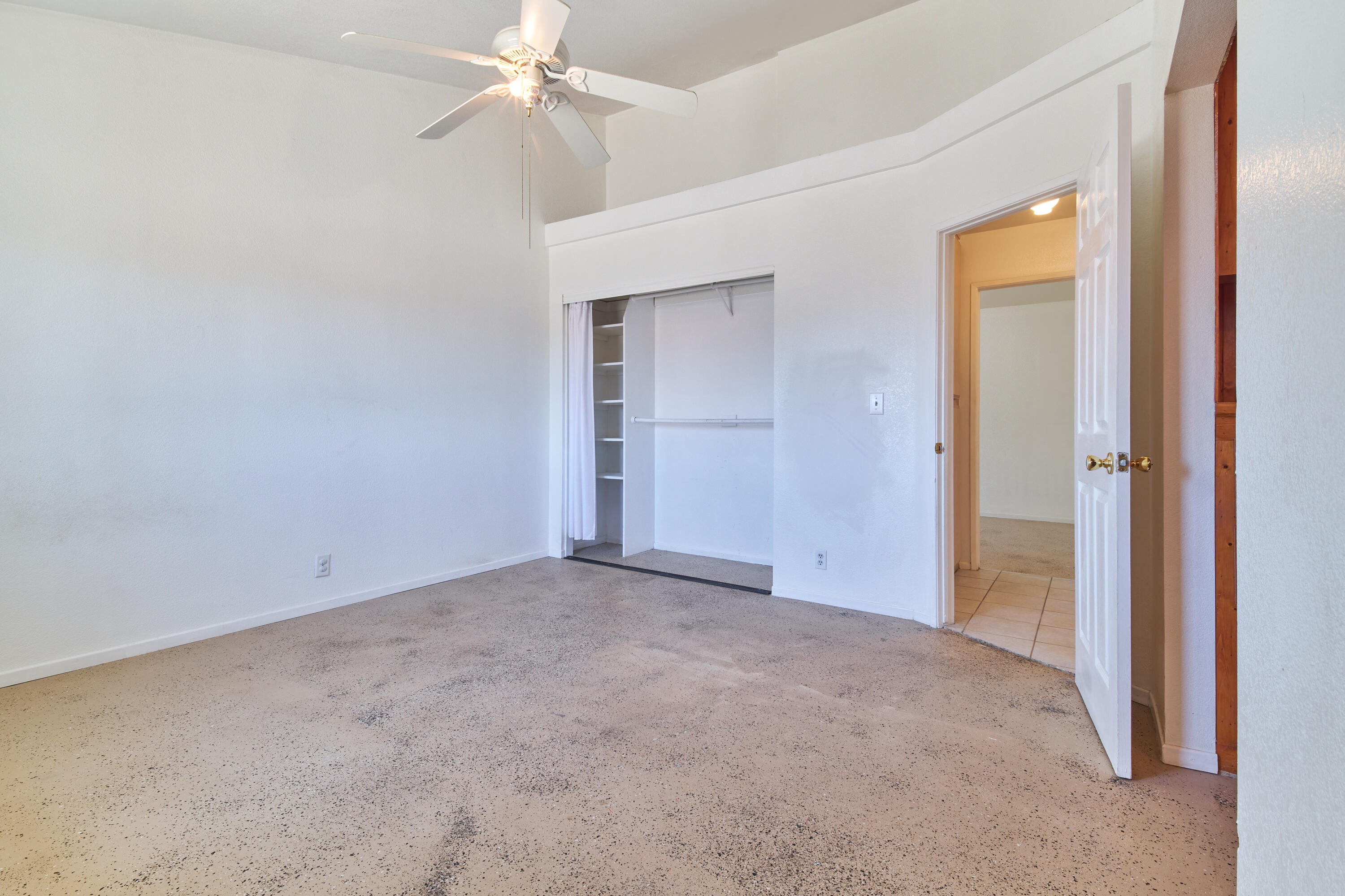 66097 San Jose Road Desert Hot Springs, CA 92240 - Photo 16 of 26 an empty room with a ceiling fan and a window