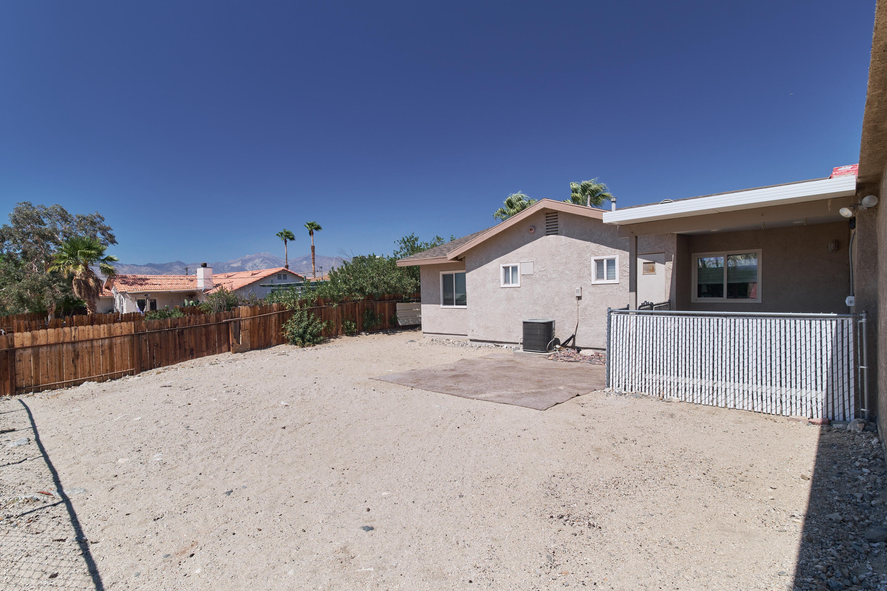66097 San Jose Road Desert Hot Springs, CA 92240 - Photo 23 of 26 a view of a house with a backyard