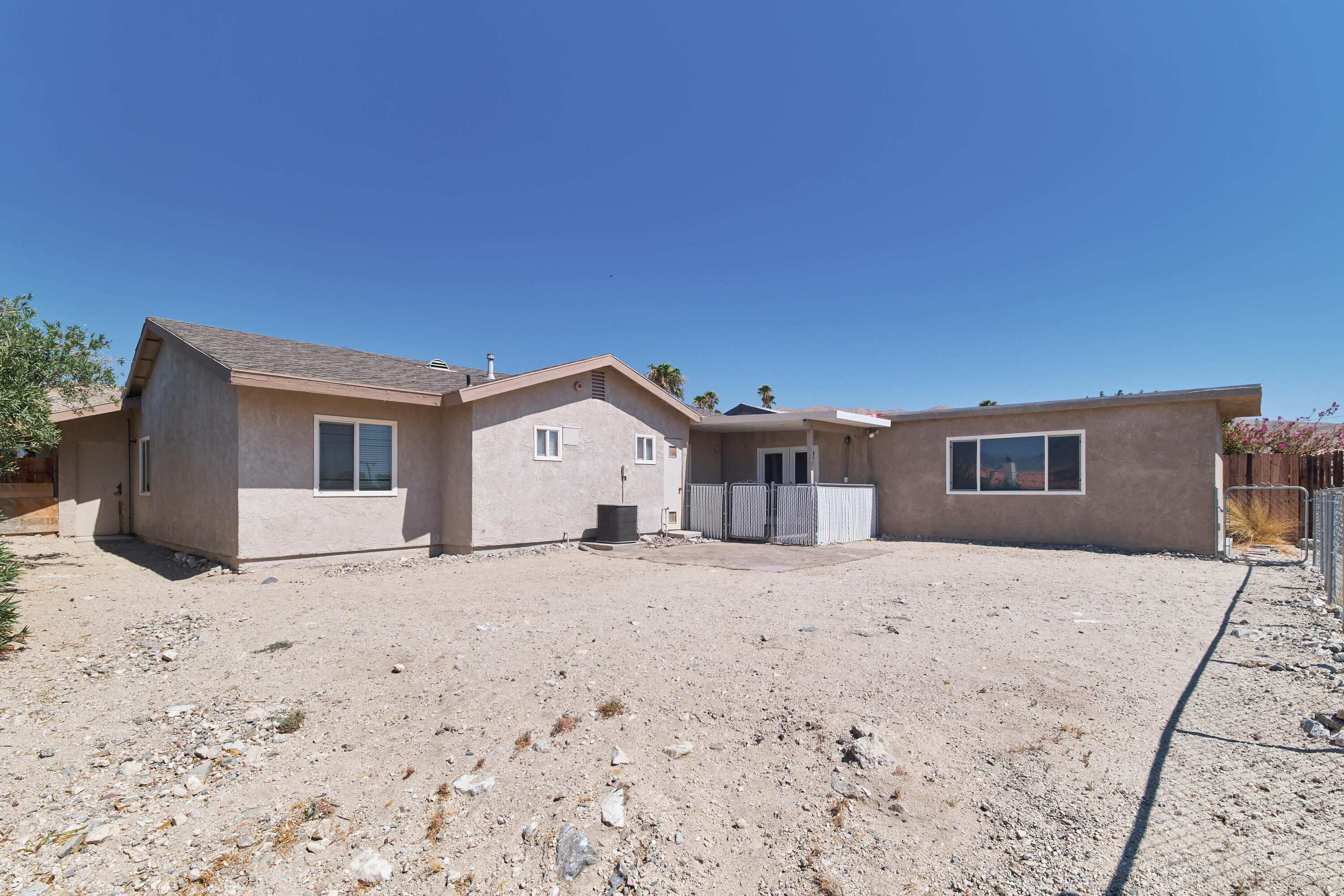 66097 San Jose Road Desert Hot Springs, CA 92240 - Photo 25 of 26 a front view of a house with a yard covered in snow