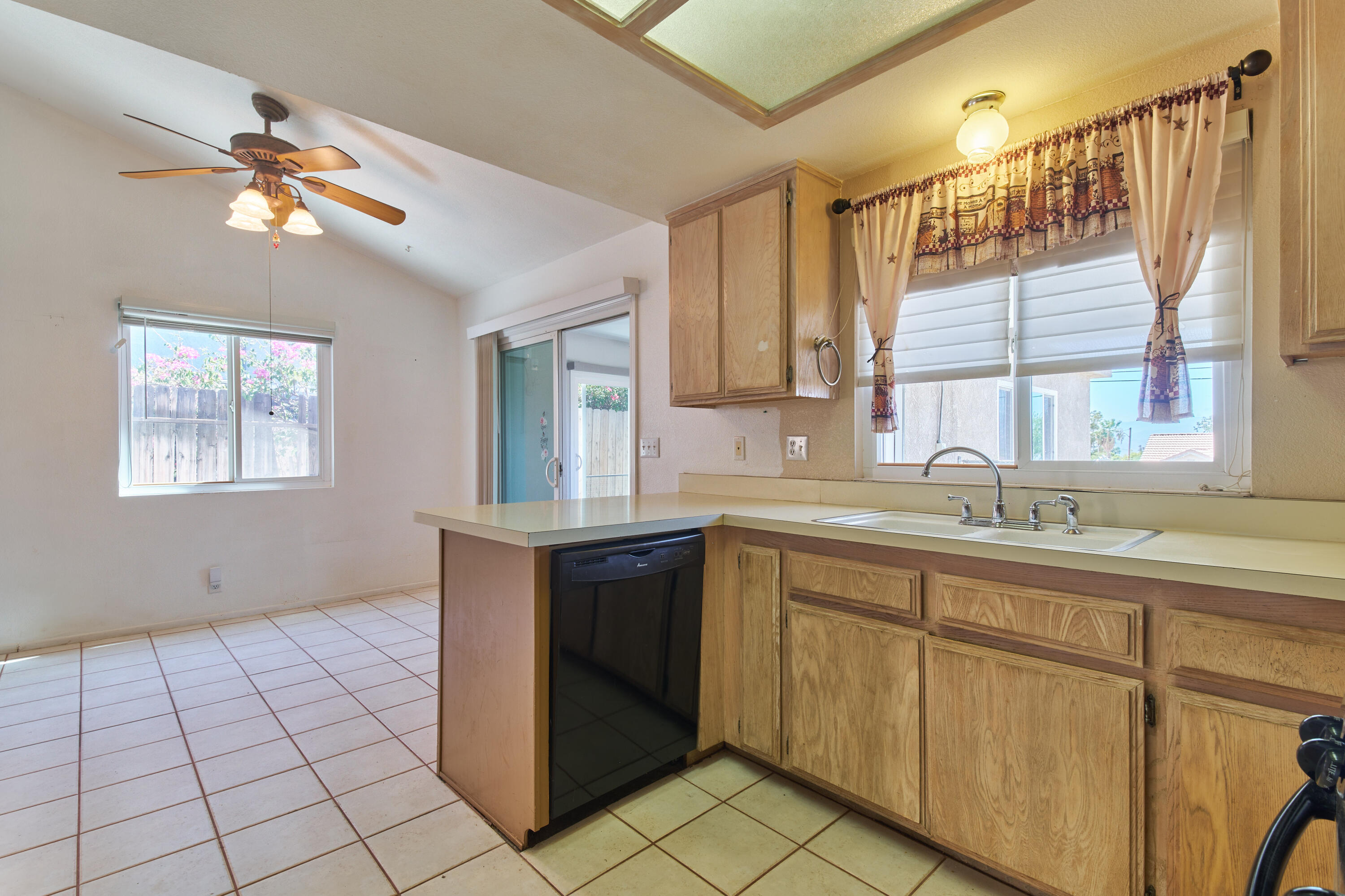 66097 San Jose Road Desert Hot Springs, CA 92240 - Photo 9 of 26 a kitchen with a sink cabinets and window