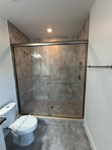 a bathroom with a shower and a toilet