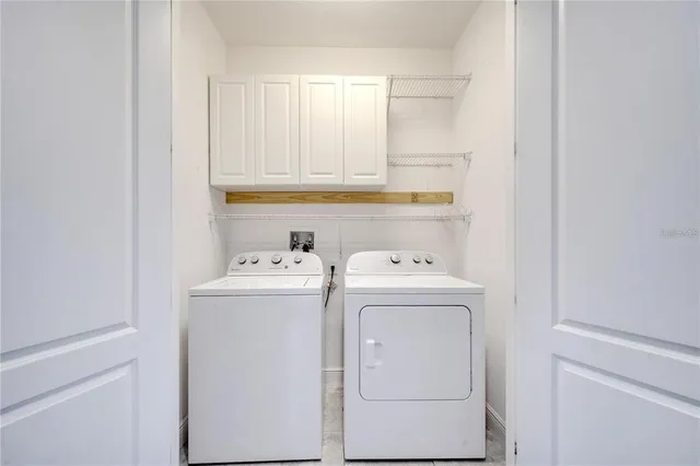 a view of storage and utility room with washer and dryer
