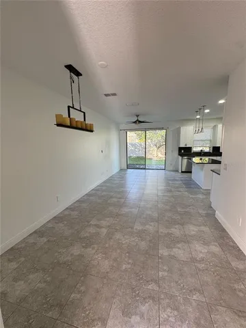 a view of a kitchen with furniture and windows