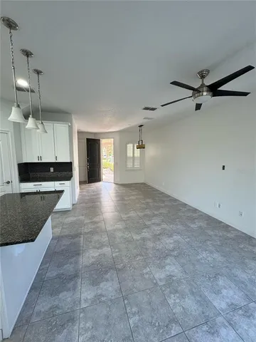 a view of a kitchen with a sink and cabinets
