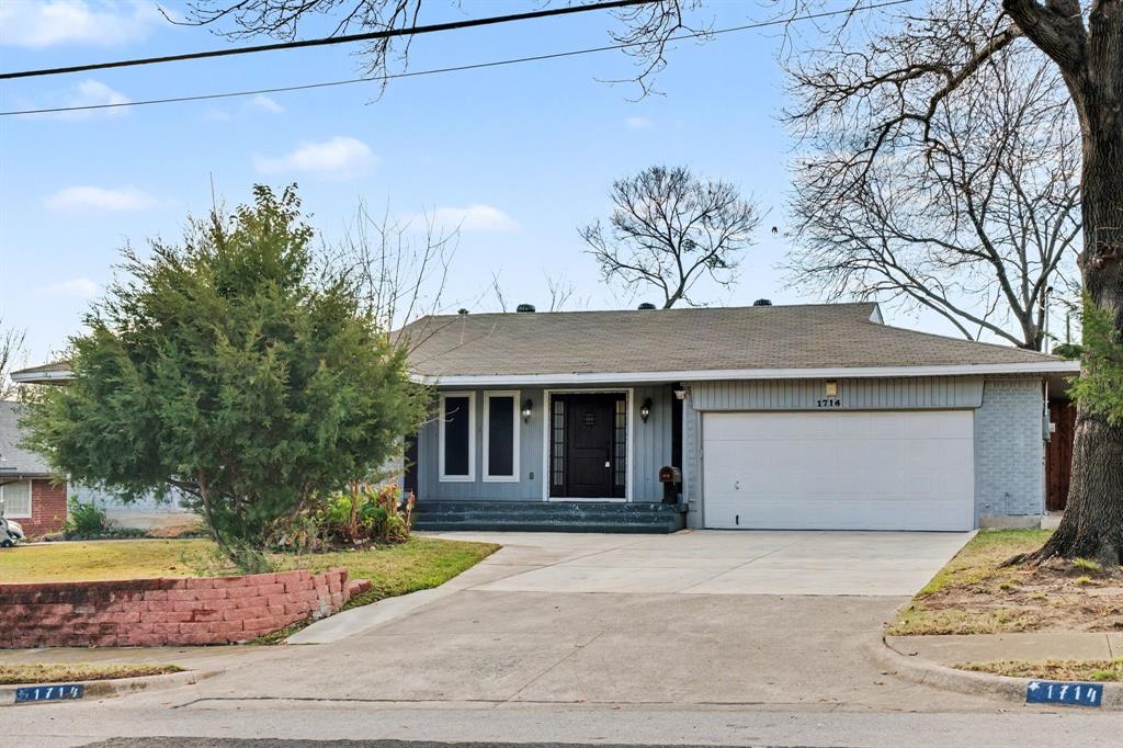 1714 East Union Bower Road Irving, TX 75061 - Photo 2 of 32 a front view of a house with a yard and garage