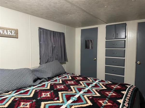 a bedroom with a bed and a lamp