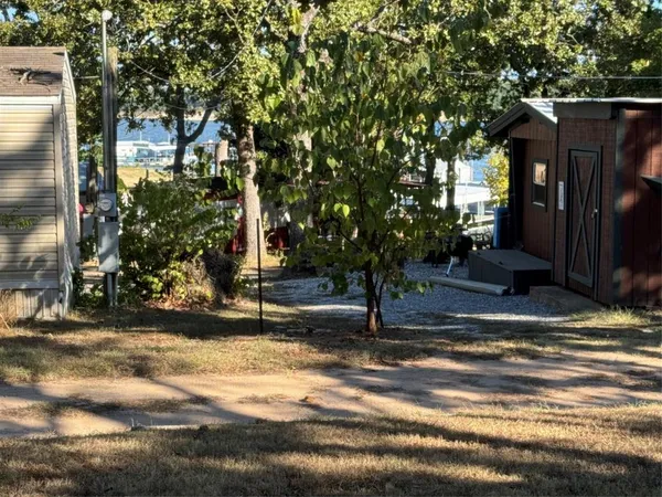 a view of a house with street that has a tree