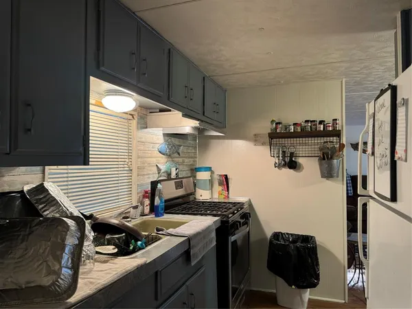 a kitchen with a stove and a refrigerator
