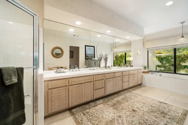 a large bathroom with a large tub and sink