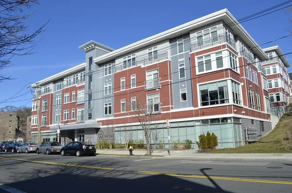 a front view of a building with street view and windows