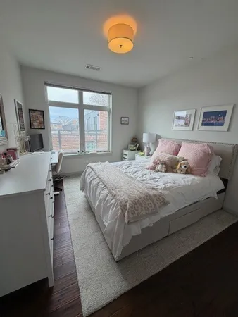 a bedroom with a bed and a large window
