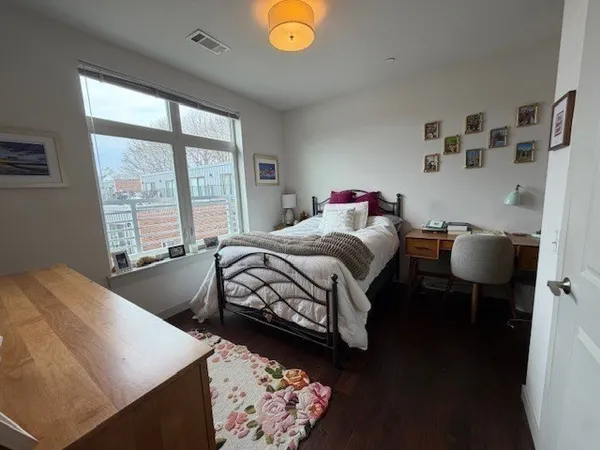 a bedroom with bed and a window