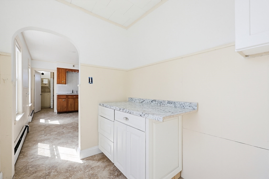 119 Hope Avenue Worcester, MA 01603 - Photo 26 of 42 a view of a hallway with wooden floor and cabinet