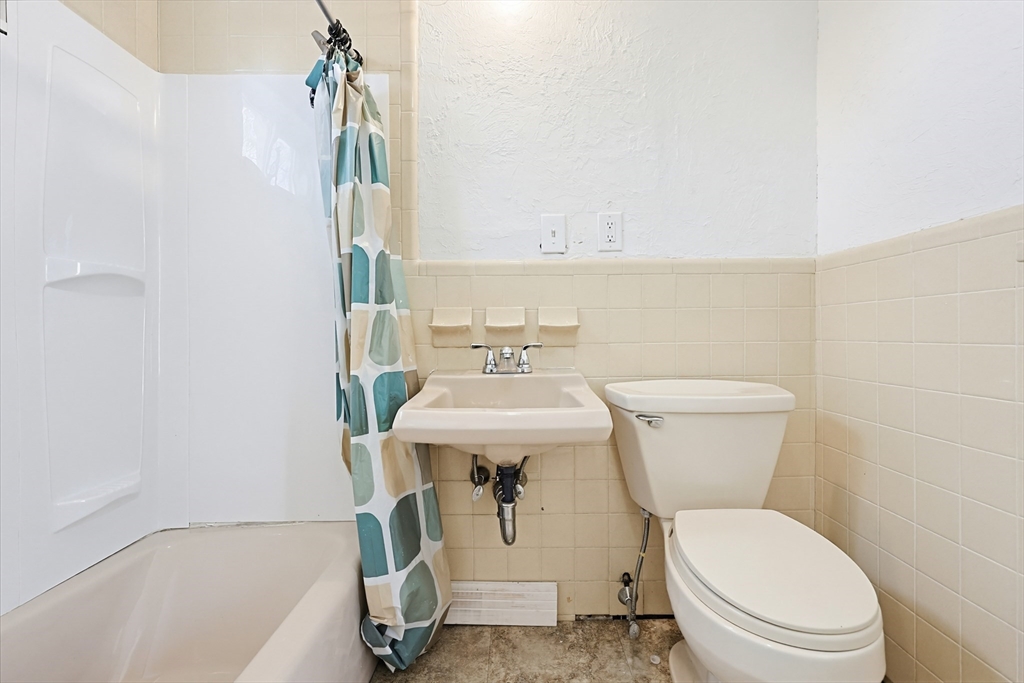 119 Hope Avenue Worcester, MA 01603 - Photo 28 of 42 a bathroom with a sink a toilet and a bathtub