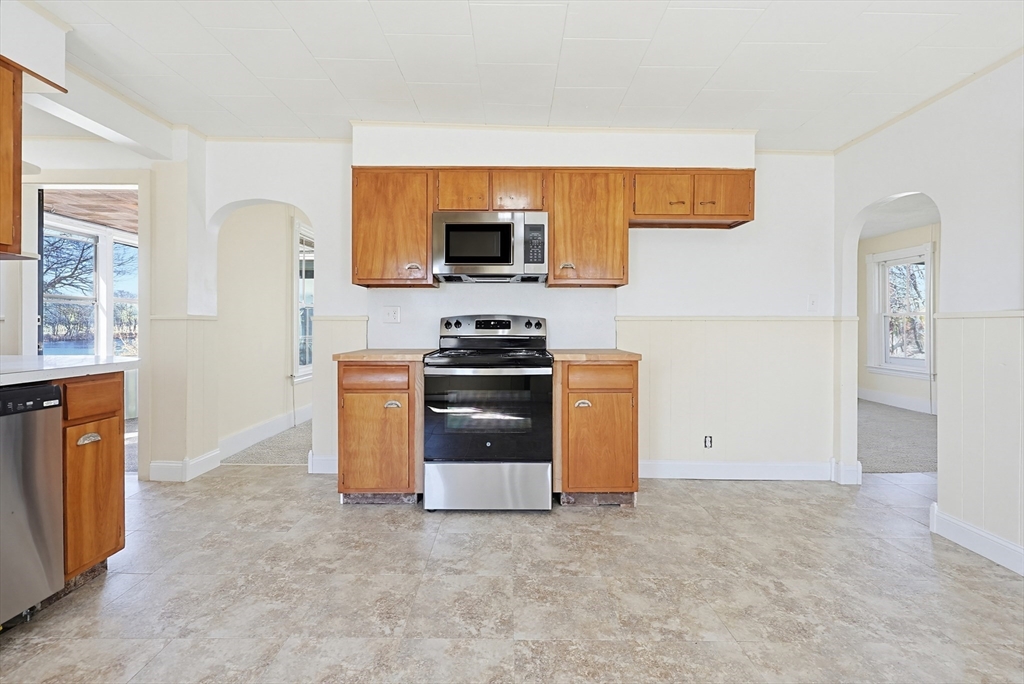 119 Hope Avenue Worcester, MA 01603 - Photo 4 of 42 a kitchen with stainless steel appliances a stove a microwave and a refrigerator