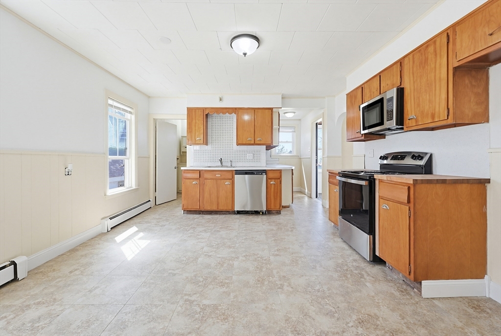 119 Hope Avenue Worcester, MA 01603 - Photo 5 of 42 a kitchen with stainless steel appliances a stove top oven a sink a refrigerator a window