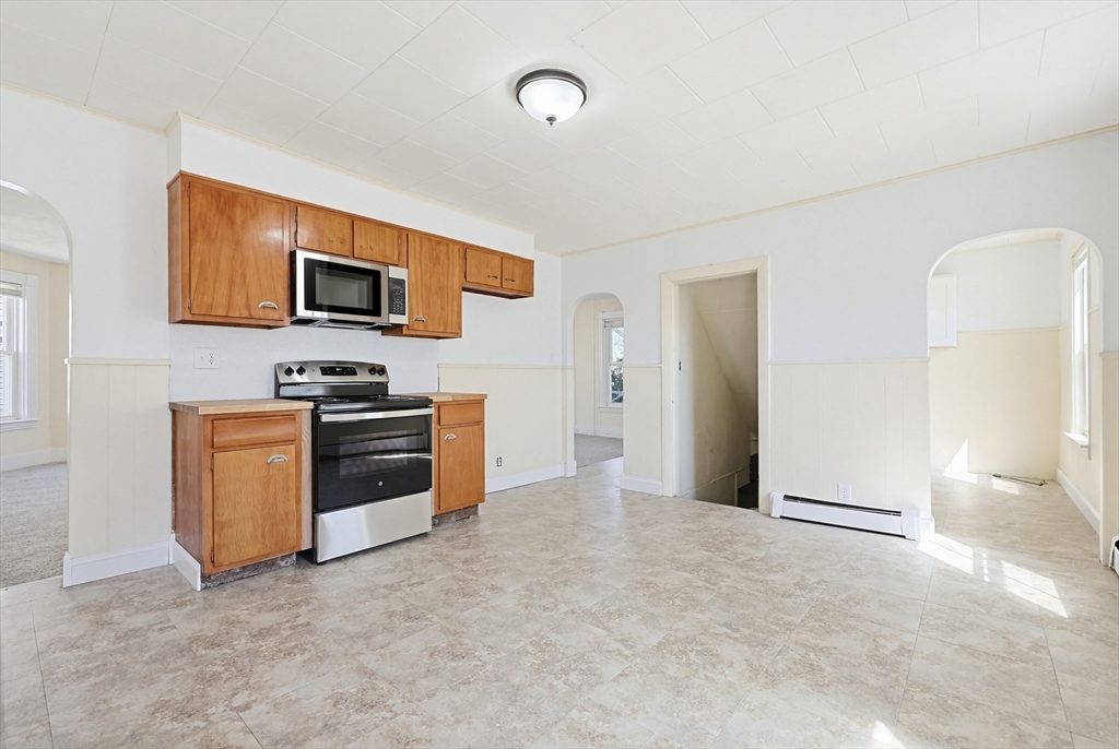 119 Hope Avenue Worcester, MA 01603 - Photo 6 of 42 a view of kitchen with microwave stove and refrigerator