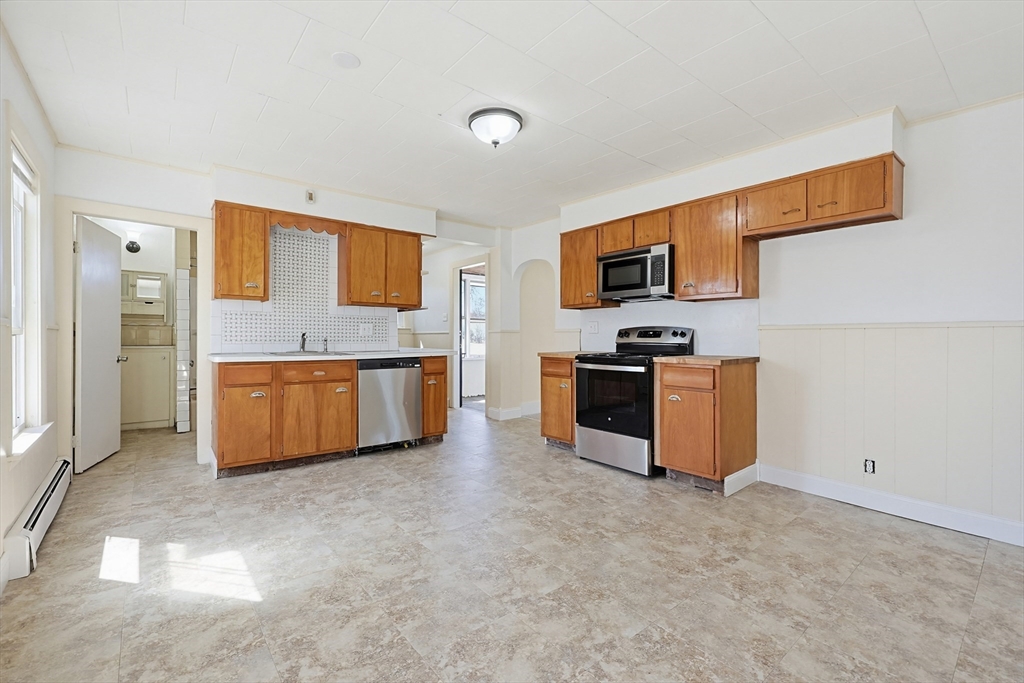 119 Hope Avenue Worcester, MA 01603 - Photo 7 of 42 a kitchen with stainless steel appliances granite countertop a stove top oven a sink and dishwasher