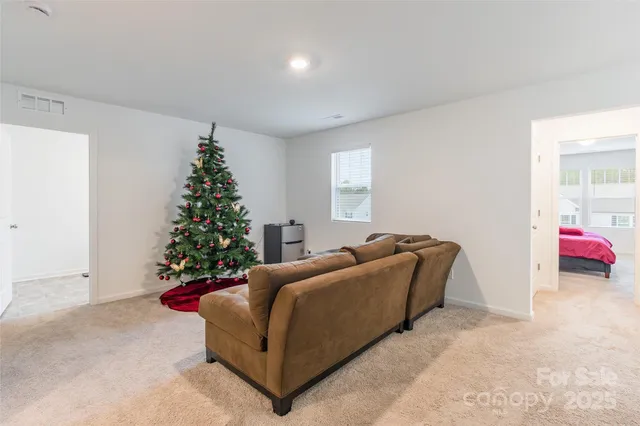a living room with furniture and a christmas tree